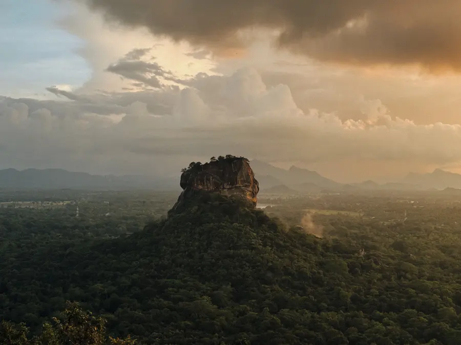 Sigiriya Rock Fortress rising above the jungle plain under a dramatic sky, Sri Lanka